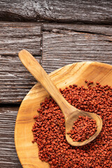 Bixa Orellana - Red organic annatto seeds in spoon and bowl