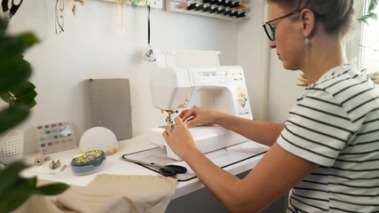 Medium shot of hands threading sewing machine, focusing on details. Meditative process of sewing helps relieve stress and boost creativity. Concept of mindfulness, DIY therapy, and relaxation.