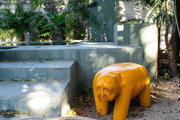 Yellow alebrije statue adorning upscale merida courtyard