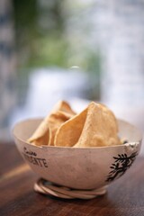 Traditional mexican totopos chips resting in a jicara bowl in merida, yucatan