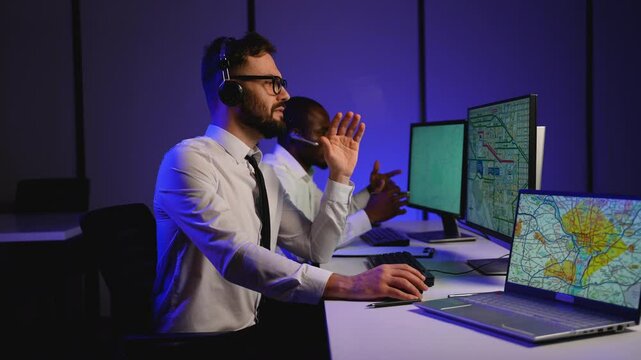 Two dispatchers coordinating truck cargo logistics in office