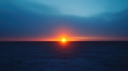 Obraz premium Vibrant Orange Sunset Over Dark Blue Ocean