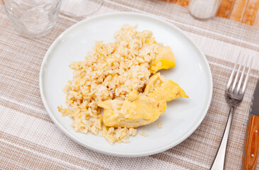Light and delicious meal of steamed chicken breast paired with basmati rice, served on classic white plate, ideal for nutritious and dietary dinner