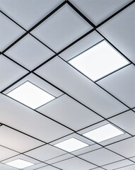 Obraz premium Sleek light panels line a minimalistic ceiling, casting a bright glow over a contemporary workspace, enhancing focus and efficiency during busy workdays.