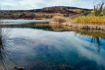 Reflective Waters and Burnt Hills of Lake Marathonas