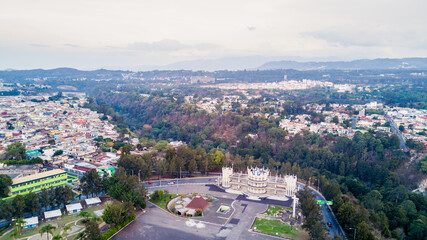 Campo de Marte public sports center. Aerial view of Guatemala City from a drone flight. Neighborhoods of different socioeconomic levels surrounding the Campo de Marte sports complex. A city surrounded