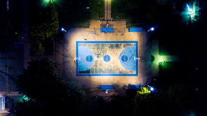 Campo de Marte public sports center. Basketball court lit up at night. Full overhead view.