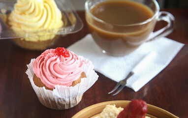 strawberry cake on a plate and cup of coffee