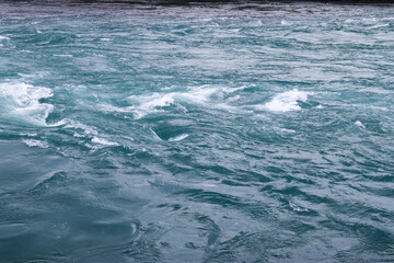 Powerful River Flowing in Iceland Creating Whirlpools and Foaming Waves