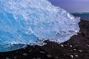 Iceberg melting on Diamond Beach, Iceland, under a clear sky