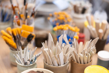 Close-up of brushes and tools for making ceramics in ceramic workshop