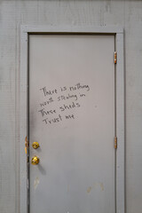Handwritten sign on outside door that reads There is Nothing Worth Stealing. in these Sheds, Trust Me, to try and deter thieves in downtown Davis, California.