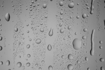 Water drops on grey glass surface, top view