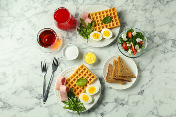 Flat lay composition with tasty brunch served on white marble table