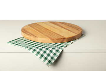 Green checkered napkin and empty wooden board on light table against white background