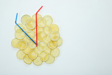 Clock made with lemon slices and cocktail straws on white background, top view. Space for text