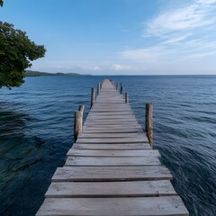 Fototapeta premium Serene lake pier extending to distant shore, tranquil waters, blue sky; travel brochure