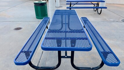 picnic tables scattered across sunny sports park near grassy fields and baseball diamonds surrounded by trees and walking paths perfect spot for relaxing lunch family gatherings or watching games