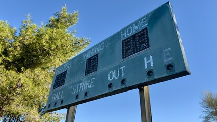 faded retro sports scoreboard with peeling paint rusted metal broken bulbs and vintage number dials evokes nostalgia for old stadium games weathered by time and frozen in classic history