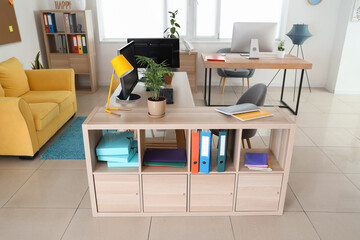 Interior of stylish office with modern workplaces and sofa