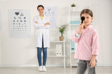 Little girl with eye occluder in clinic