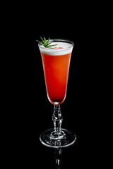 Winter sour cocktail in a glass on a black background