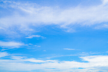 Obraz premium Blue sky and white cirrocumulus clouds texture background. Blue sky on sunny day. Summer sky. Cloud formation. Fluffy clouds. Nice weather in summer season. Weather pattern. Atmospheric phenomenon.