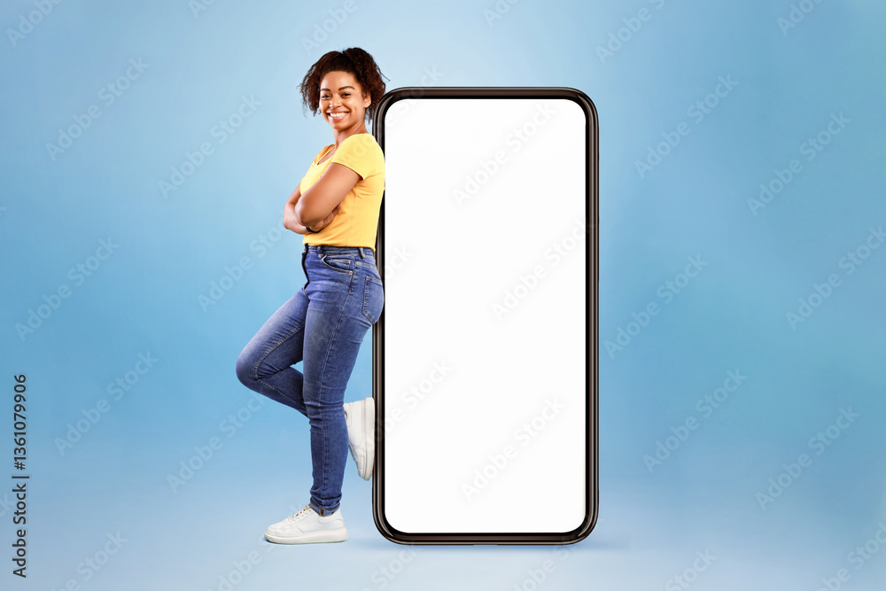 Aufkleber full length of joyful african american woman leaning on big cellphone with empty space for mobile ap