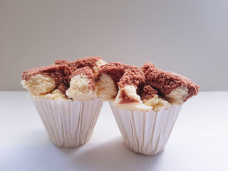 Chocolate flavored steamed buns on white background.