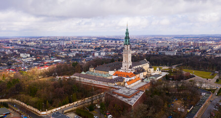 Naklejka premium Aerial view of active Catholic Jasna Gora Monastery in Czestochowa on background with modern cityscape in spring, Poland
