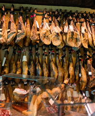 Legs of traditional Spanish jamon ready for sale in grocery