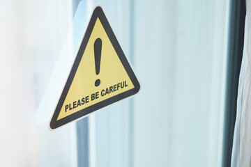 Caution sign urging attention in indoor setting