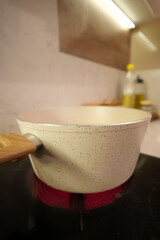 Cooking with a pot on the stove in modern kitchen setting