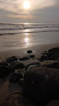 Beautiful sunset at the beach. Close up sea, sand and sky beach. Colorful sunset nature landscape. Sunlight feflect inspire and calm. Seascape scenery