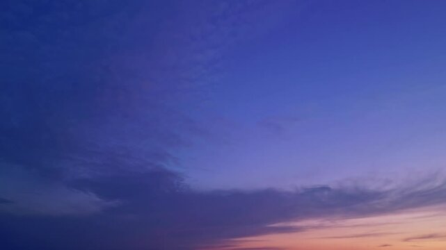 Beautiful vivid sunset sky with soft gradient of blue and orange hues in the evening.
