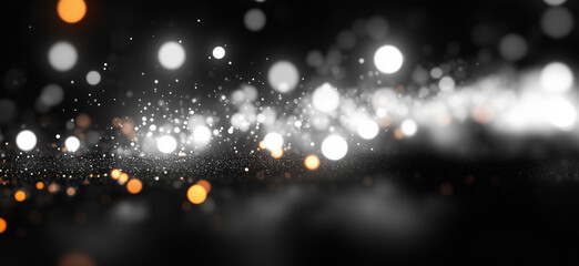 A glittering, abstract background with white and orange bokeh lights.