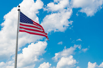 American flag waving for independence day. Flag of the USA. National waving flag of united states on blue sky. Independence day. Patriotic symbol. American Flag for Memorial Day or 4th of July