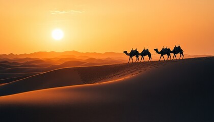 Naklejka premium Silhouette of a camel caravan strolling through the undulating sand dunes at sunset