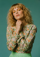 Fashion Portrait of Woman in Colorful Floral Top with Bold Makeup