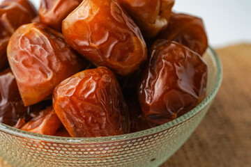 Dates fruit sukari or kurma sukari, in bowl isolated on white background