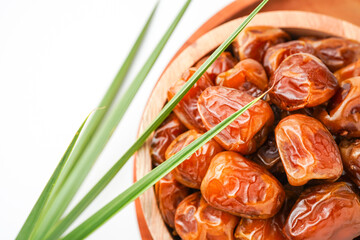 Dates fruit sukari or kurma sukari, in wooden bowl isolated on white background