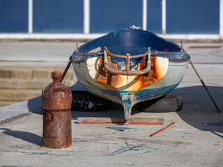 Old fishing boat under repairs in the harbour