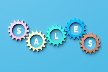 Colorful gears rotating and showing sales word on blue background