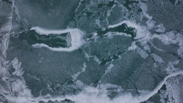 Frozen Lake Erie shoreline, aerial view of cracked ice patterns and icy waters