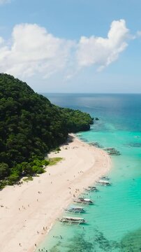 Beautiful aerial view of Puka Shell Beach with crystal clear water and white sand. Boracay, Philippines. Vertical view.