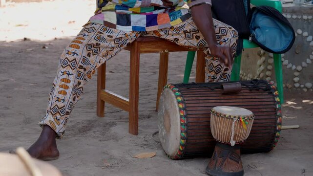 Dundun player and small Djembe, West African Drums