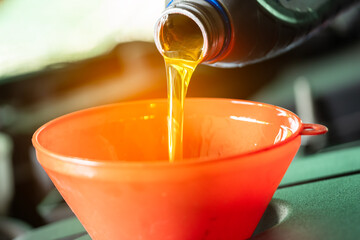 Refueling and pouring oil quality into the engine motor car Transmission and Maintenance...
