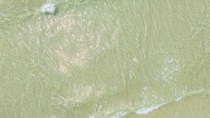 Nature of the beach and sea Summer with sunshine, sandy beaches, clear blue waters sparkling against the blue sky. On an island with good ecology and environment Background for summer vacation