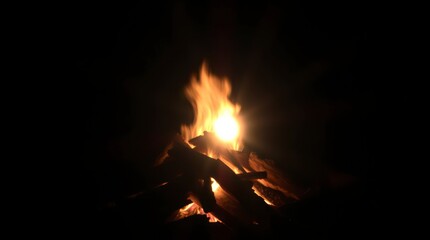 Burning Campfire at Night with Bright Flames and Glowing Embers