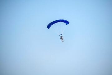Paragliding on isolated blue sky in mid-air 